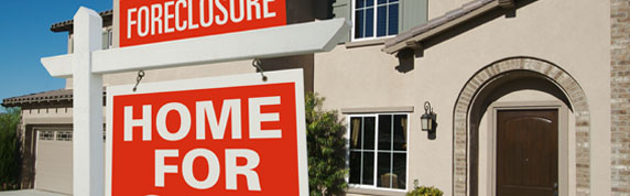 image: foreclosure sign in front of house